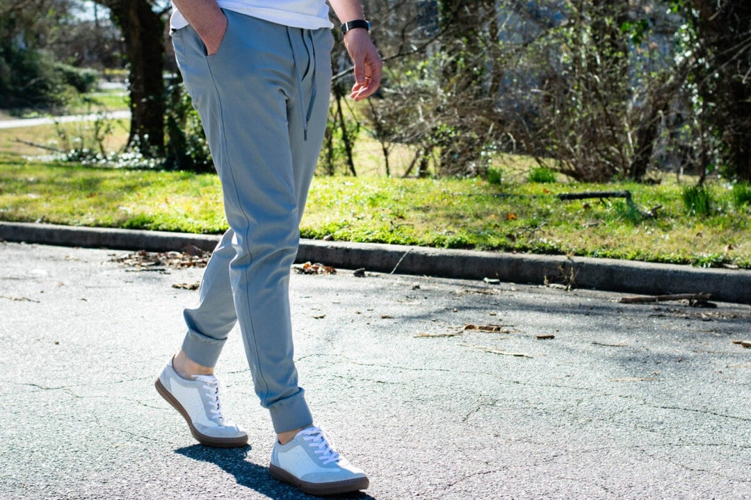Joggers on a man outside on a street.